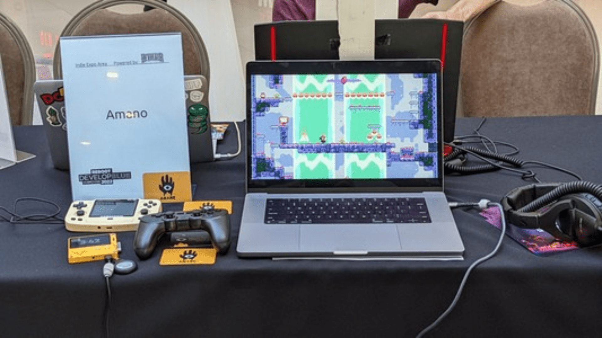 Reboot conference booth table with a game running on a laptop